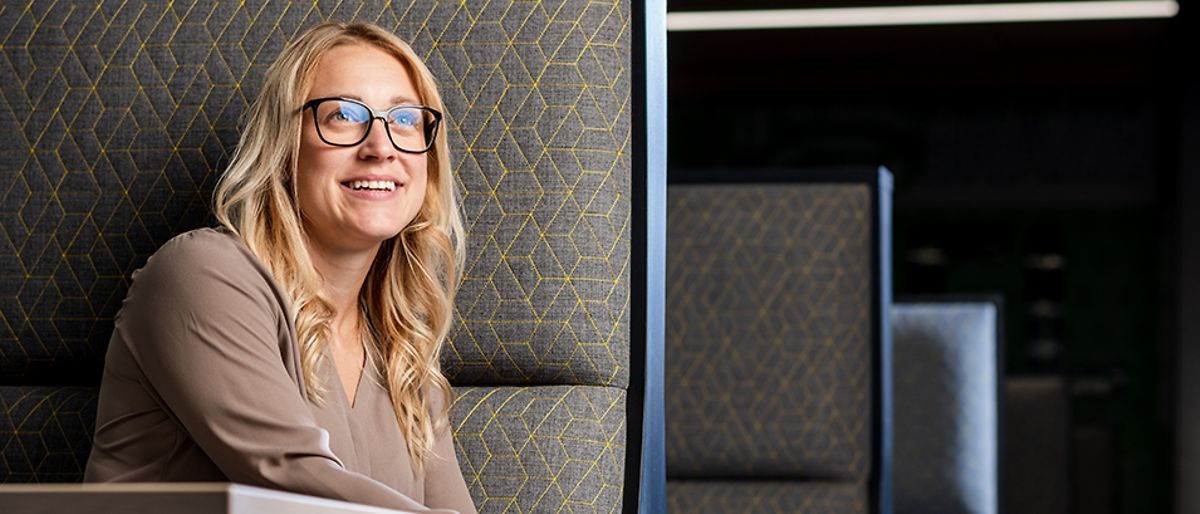 An employee sits in a restaurant booth