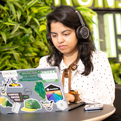 An employee from India works on her laptop