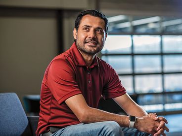 John Deere employee posing in an office environment. 