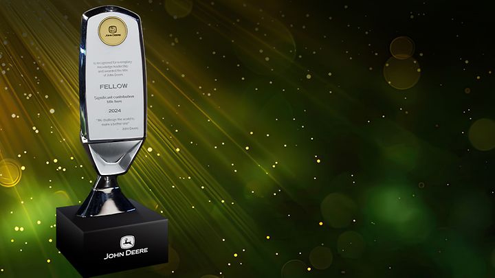 A bright green and yellow digital background highlights the Fellows award plaque